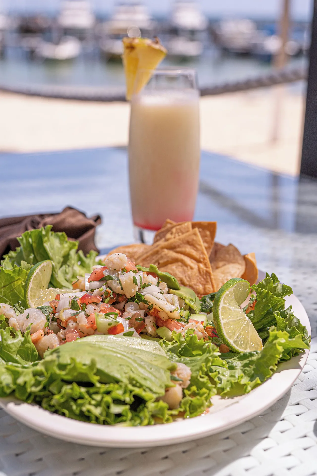 Seafood plate with tortilla chips and a tropical drink at All Ritmo Cancun Resort & Water Park.