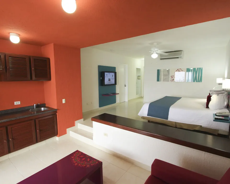 Junior Suite Sea View kitchenette and king bed at All Ritmo Cancun Resort & Water Park.