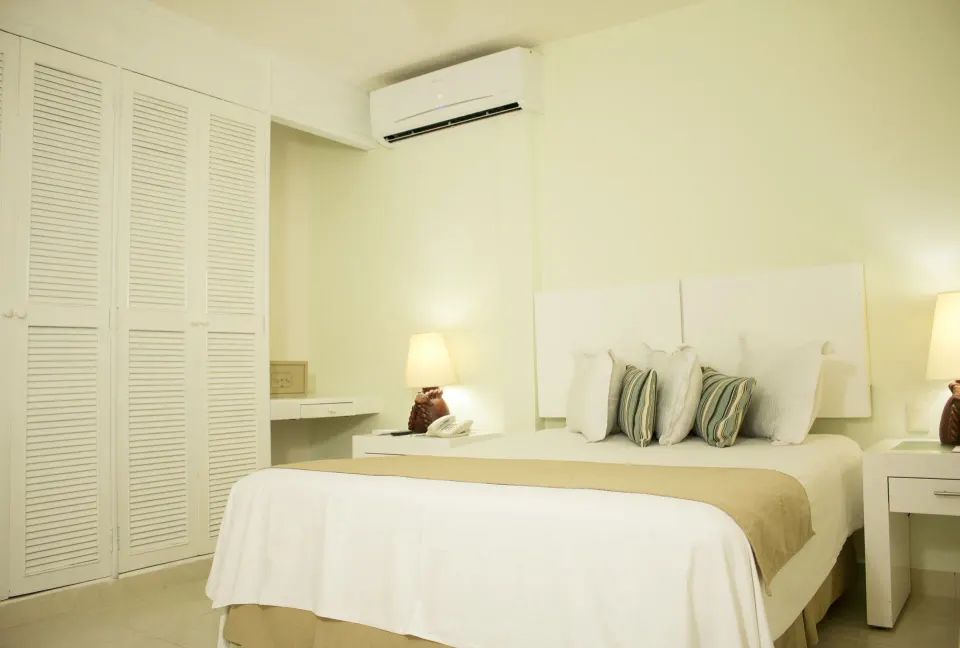 Master Suite Garden View bedroom with king bed at All Ritmo Cancun Resort & Water Park.