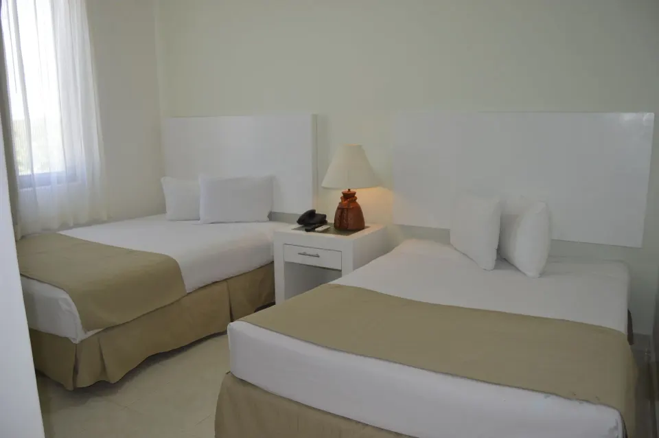 Master Suite Garden View twin bedroom at All Ritmo Cancun Resort & Water Park.