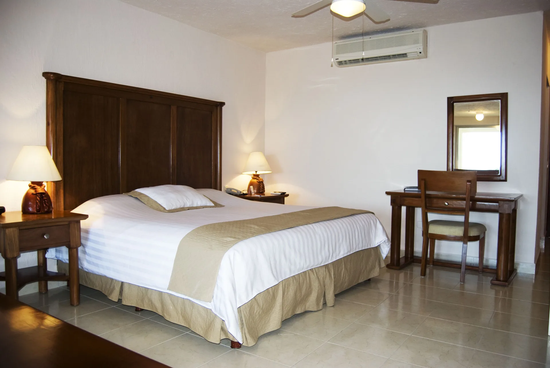 Standard room with one bed and writing desk at All Ritmo Cancun Resort & Water Park.