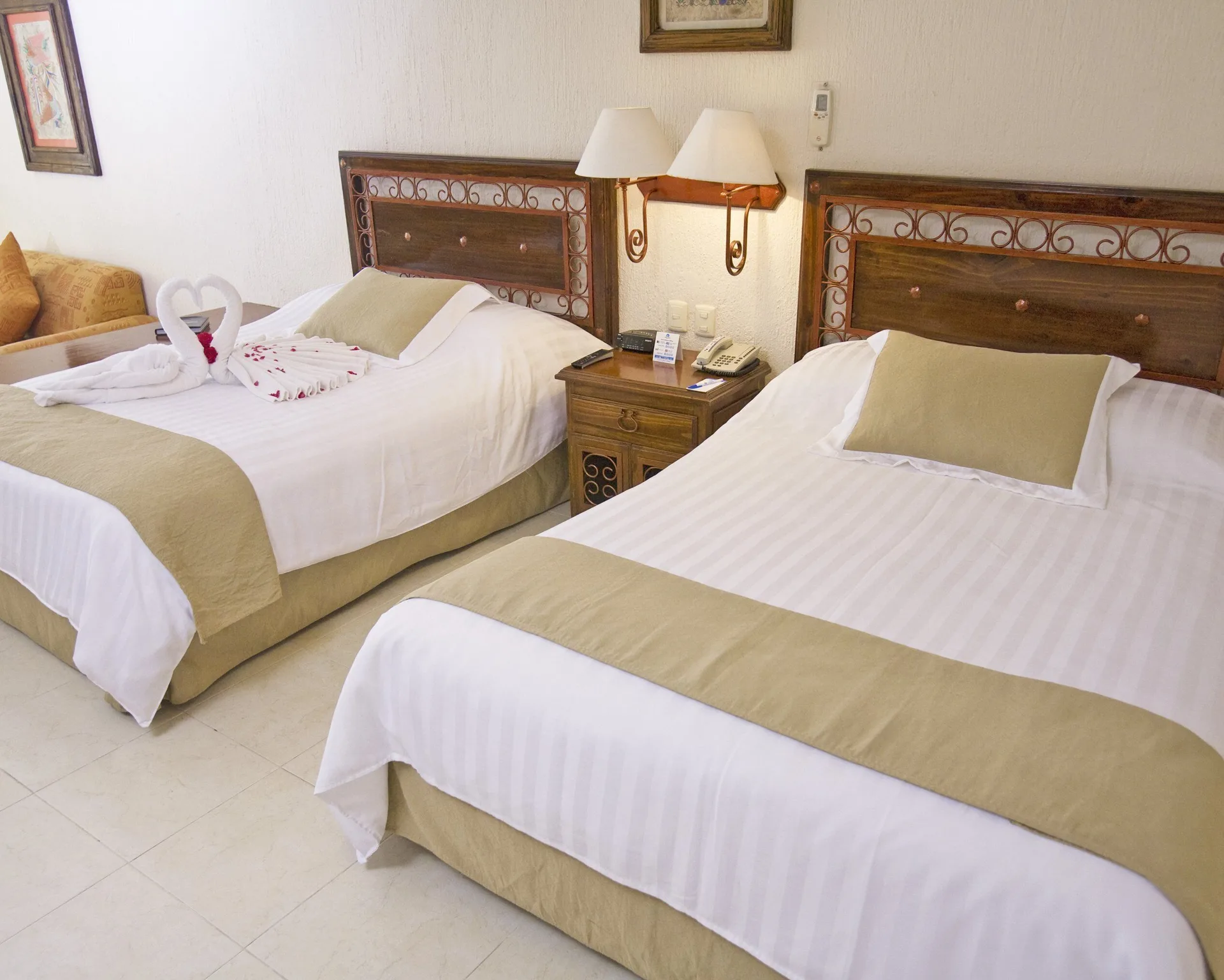 Standard room with two beds and towel decor at All Ritmo Cancun Resort & Water Park.