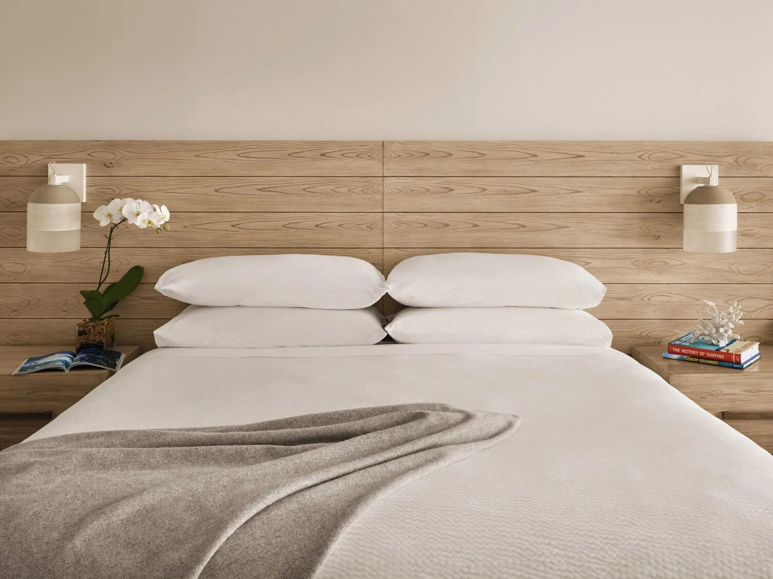 Classic Room king bed with wood headboard at 'Alohilani Resort Waikiki Beach.