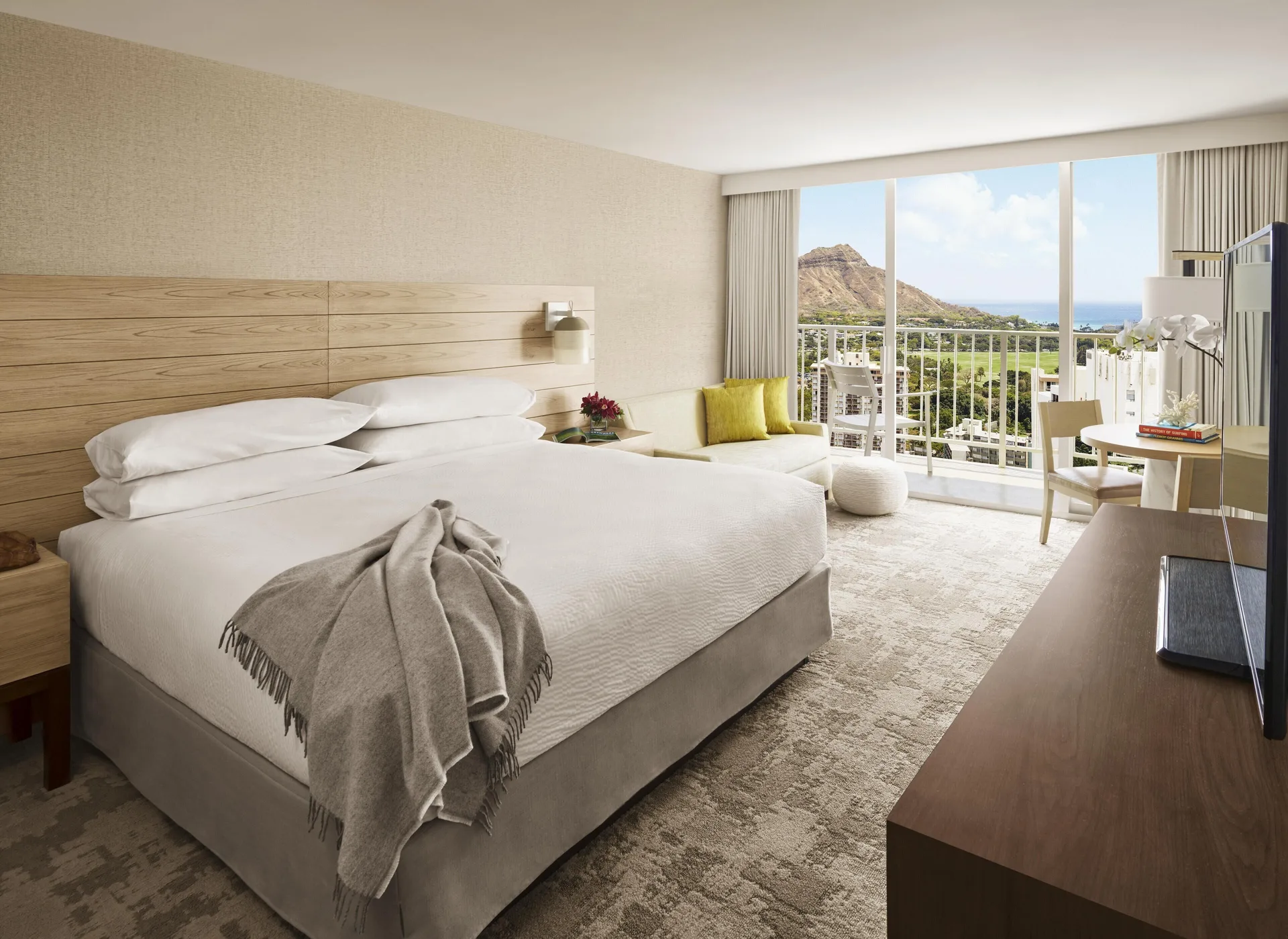Mountain View guest room with king bed and balcony at 'Alohilani Resort Waikiki Beach.