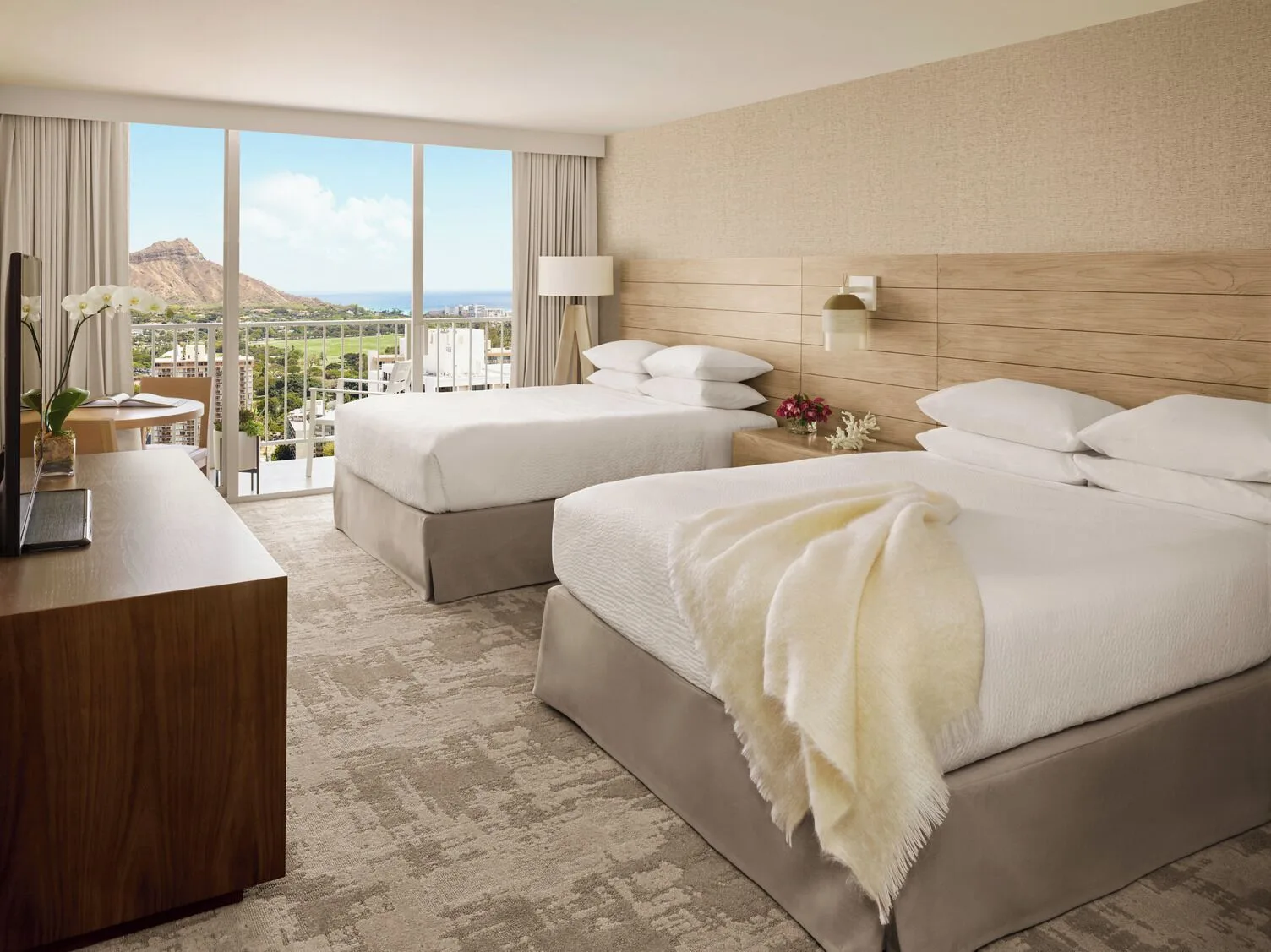 Two-bed ocean-view guest room with Diamond Head at 'Alohilani Resort Waikiki Beach.