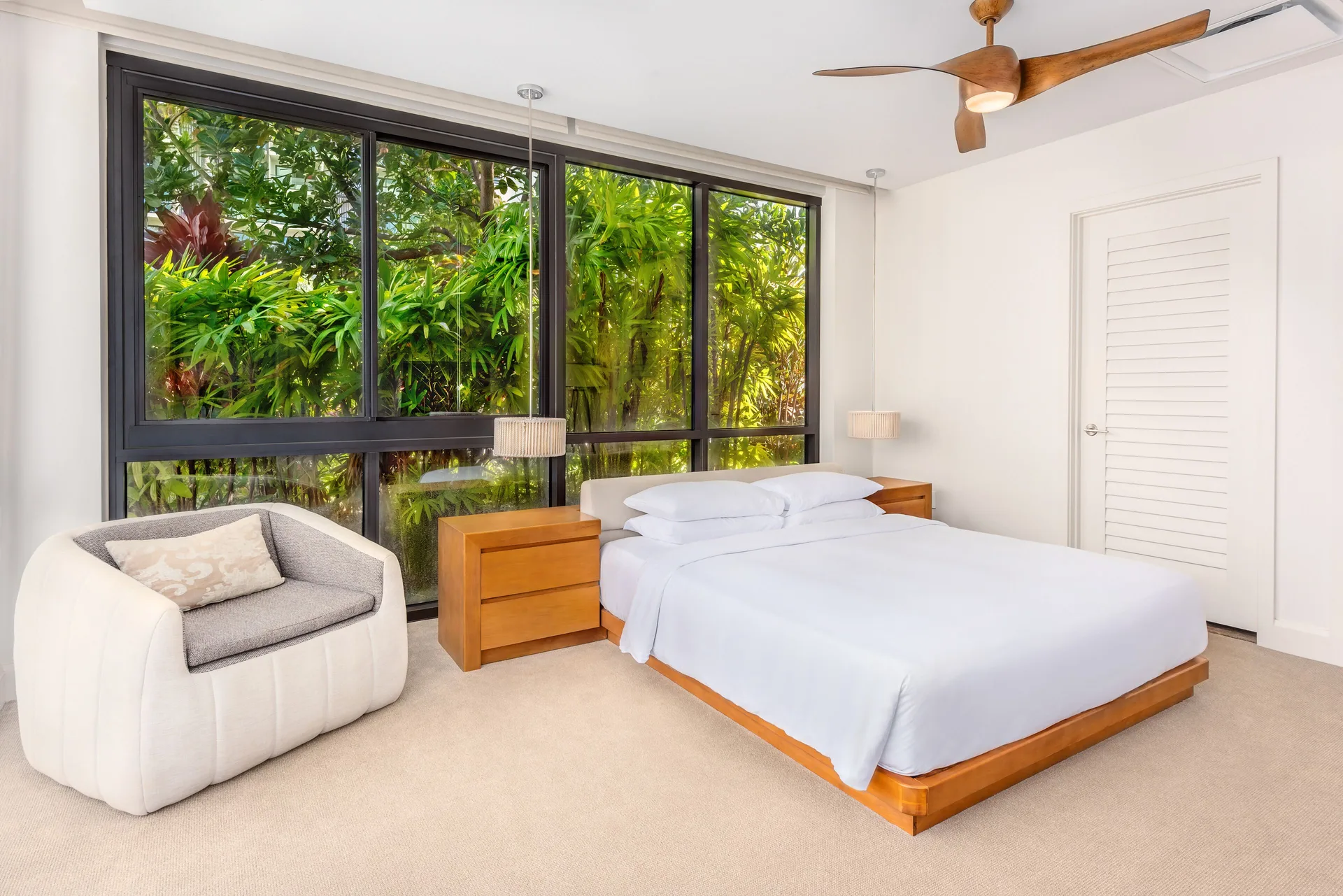 Bright guest room with king bed and tropical garden windows at Andaz Maui at Wailea Resort.