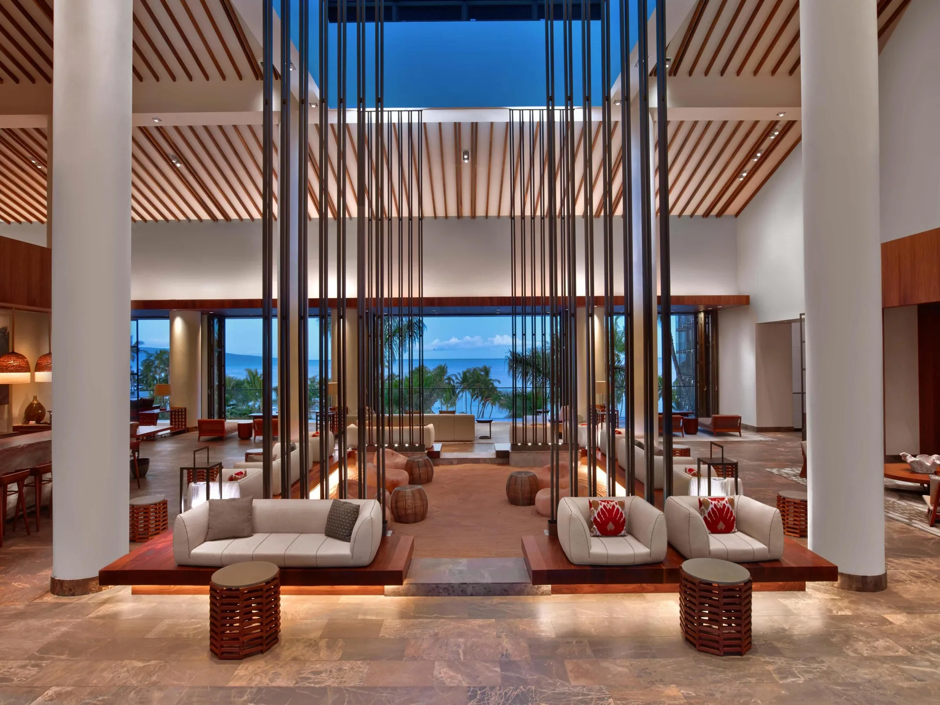 Lobby seating framed by tall screens and ocean views at Andaz Maui at Wailea Resort.