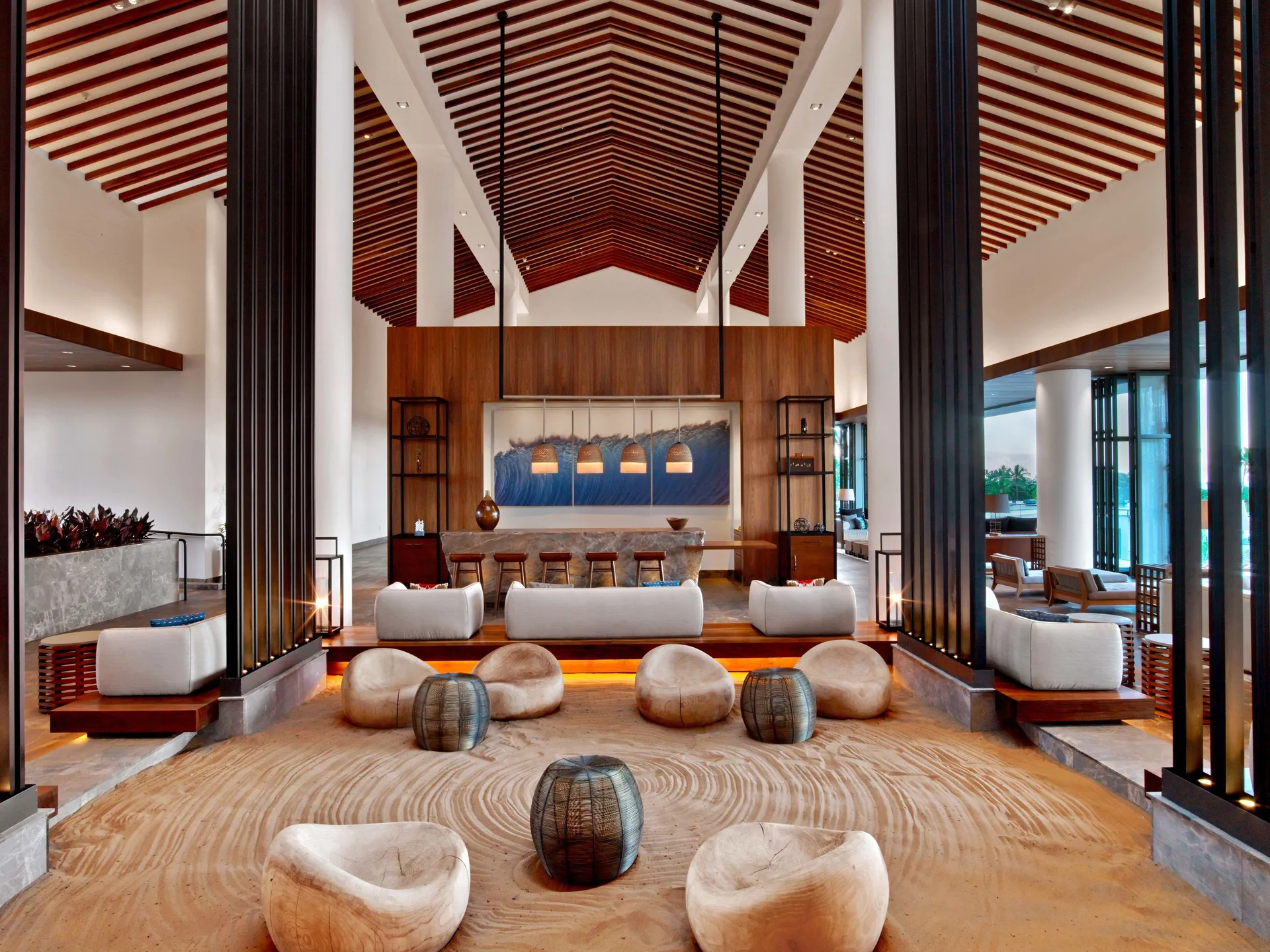 Open-air lobby seating with sand garden and high wood ceiling at Andaz Maui at Wailea Resort.