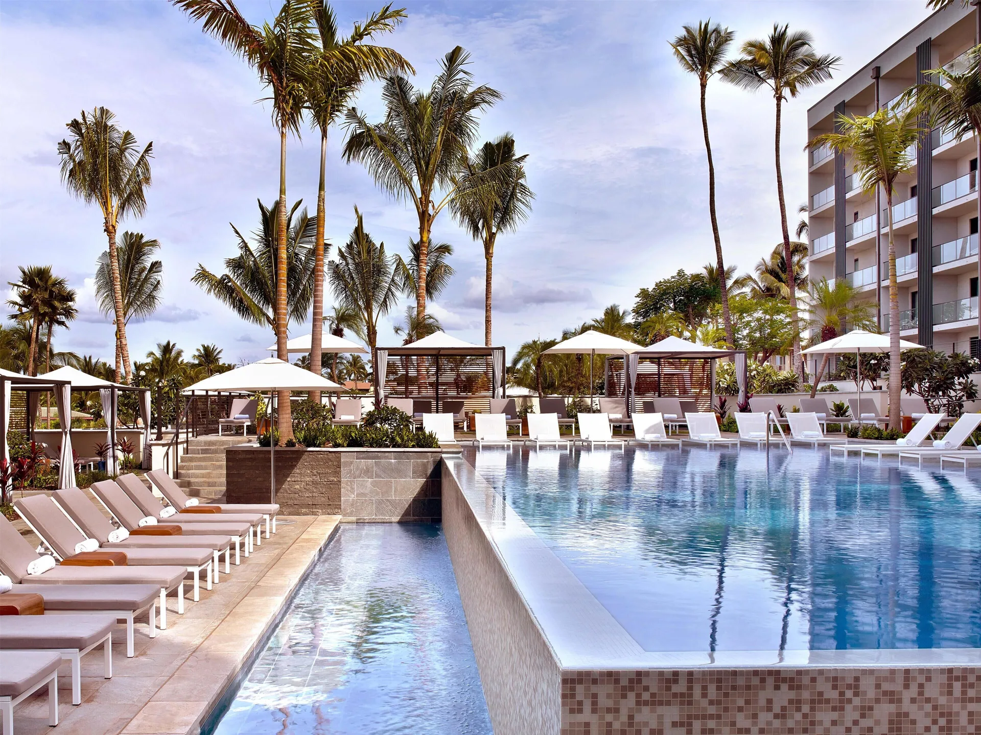 Terraced pool with cabanas and lounge chairs at Andaz Maui at Wailea Resort.