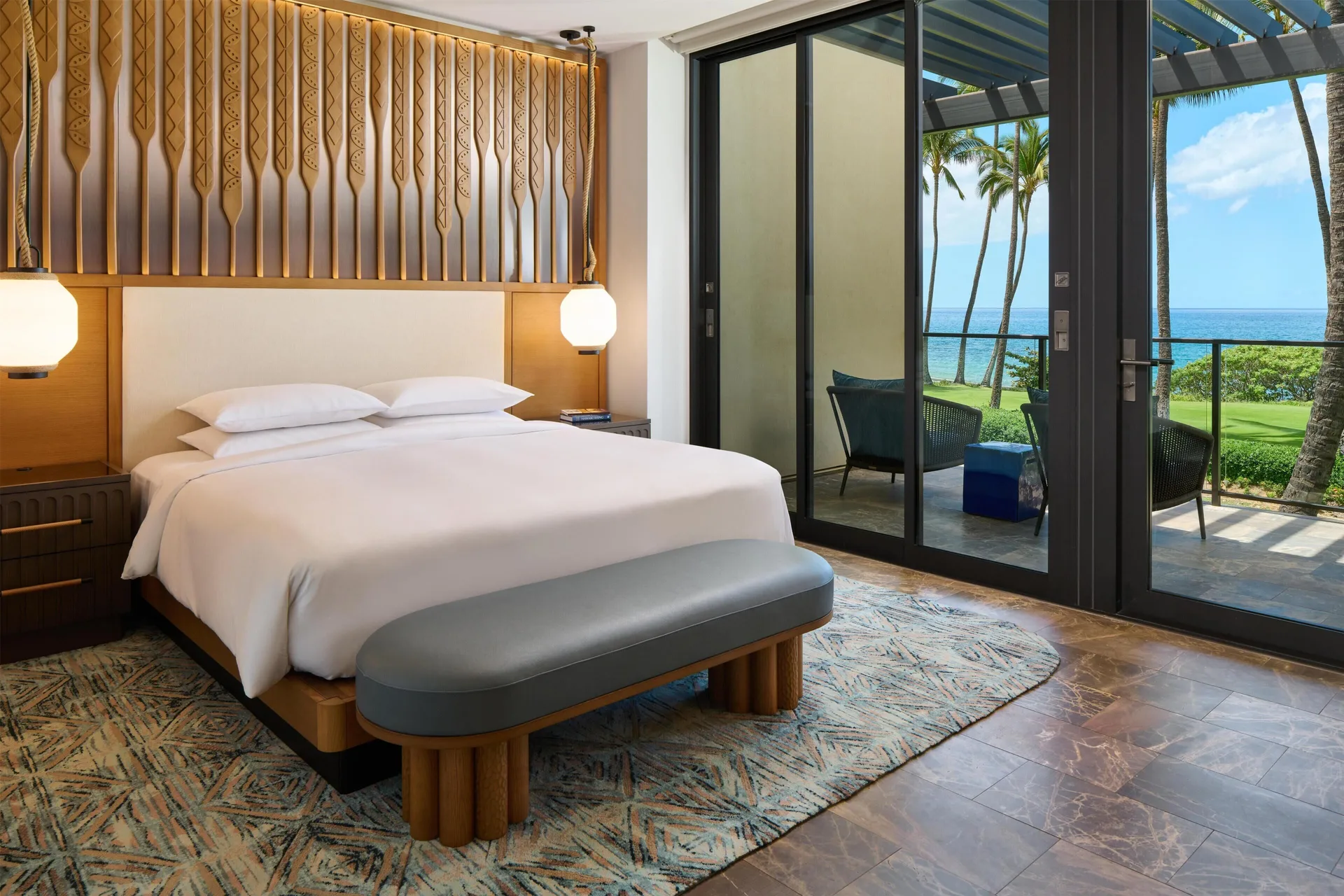 King bed with lanai and ocean view in a villa bedroom at Andaz Maui at Wailea Resort.