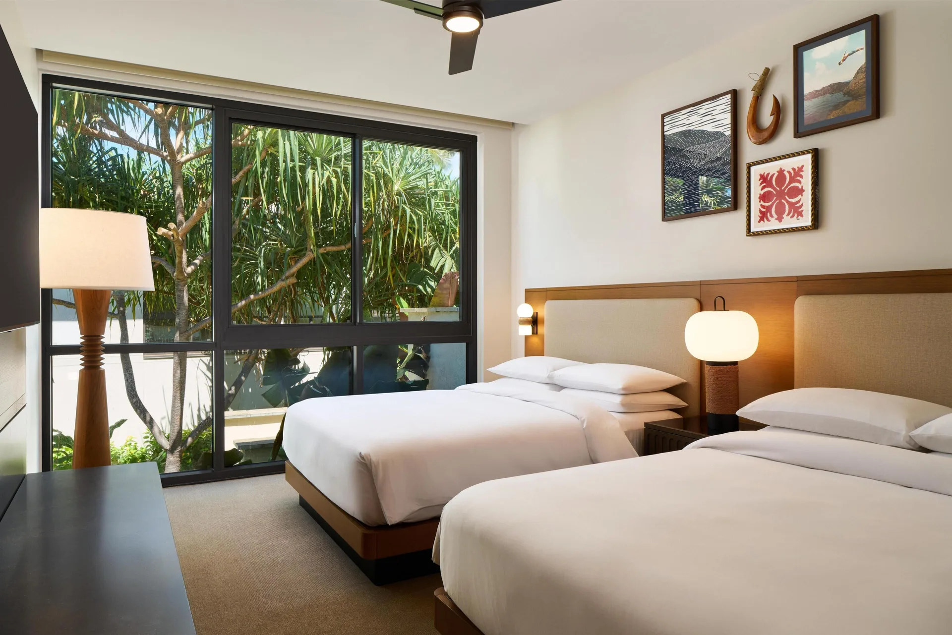 Two queen beds in a villa bedroom with tropical window views at Andaz Maui at Wailea Resort.