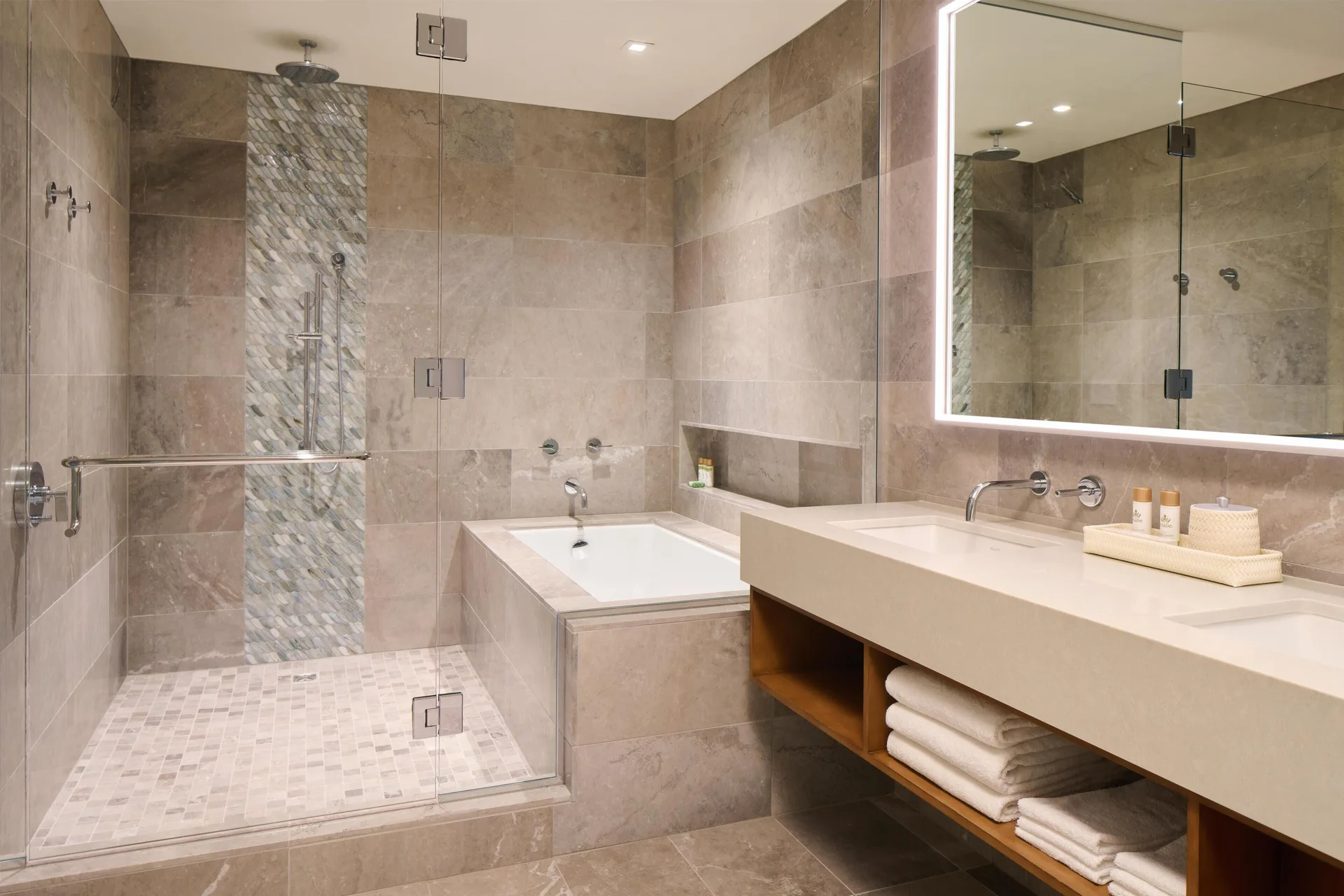 Bathroom with tub and glass shower in the 3 Bedroom Ilikai Villa at Andaz Maui at Wailea Resort.