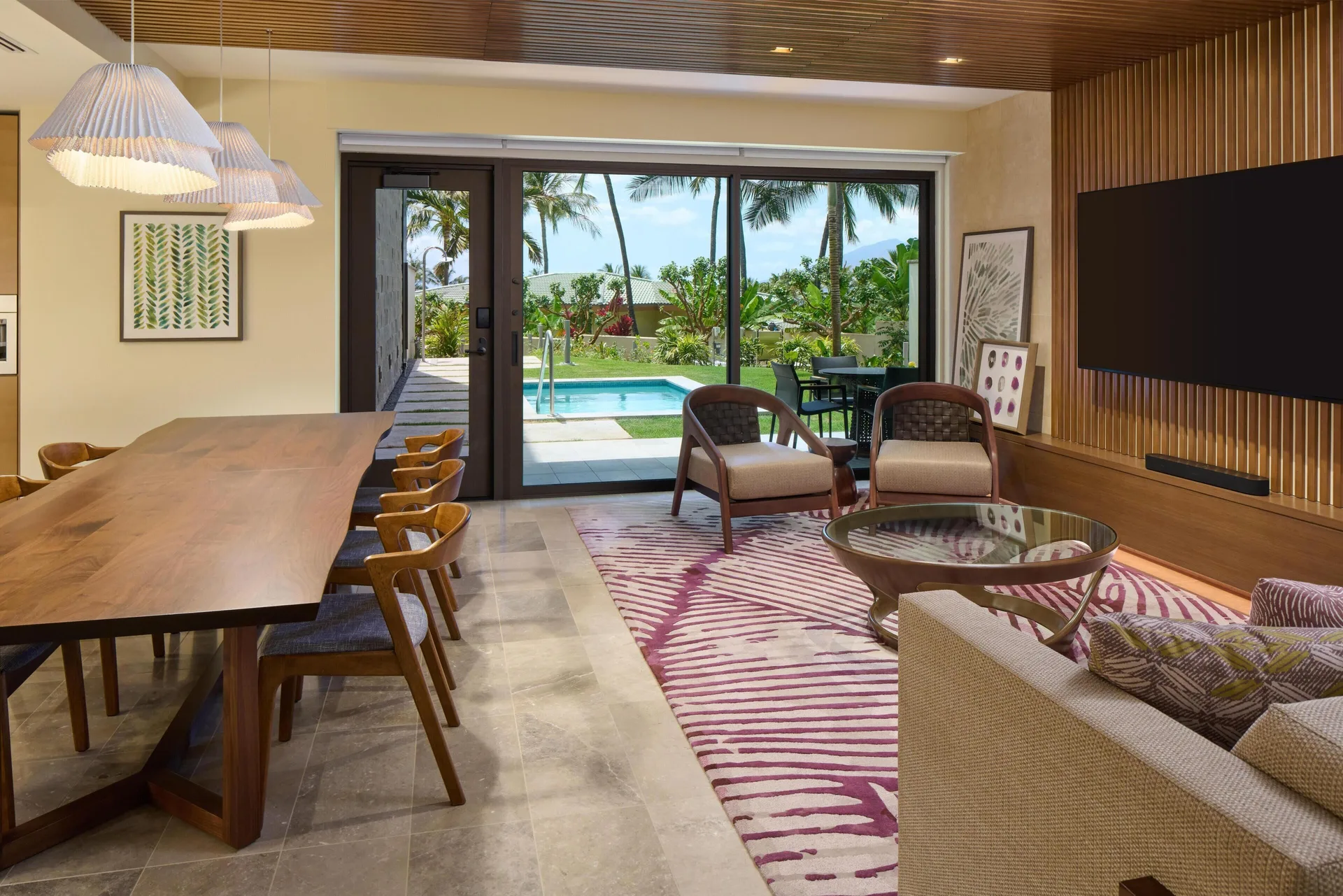 Living and dining area opening to a private pool at Andaz Maui at Wailea Resort.
