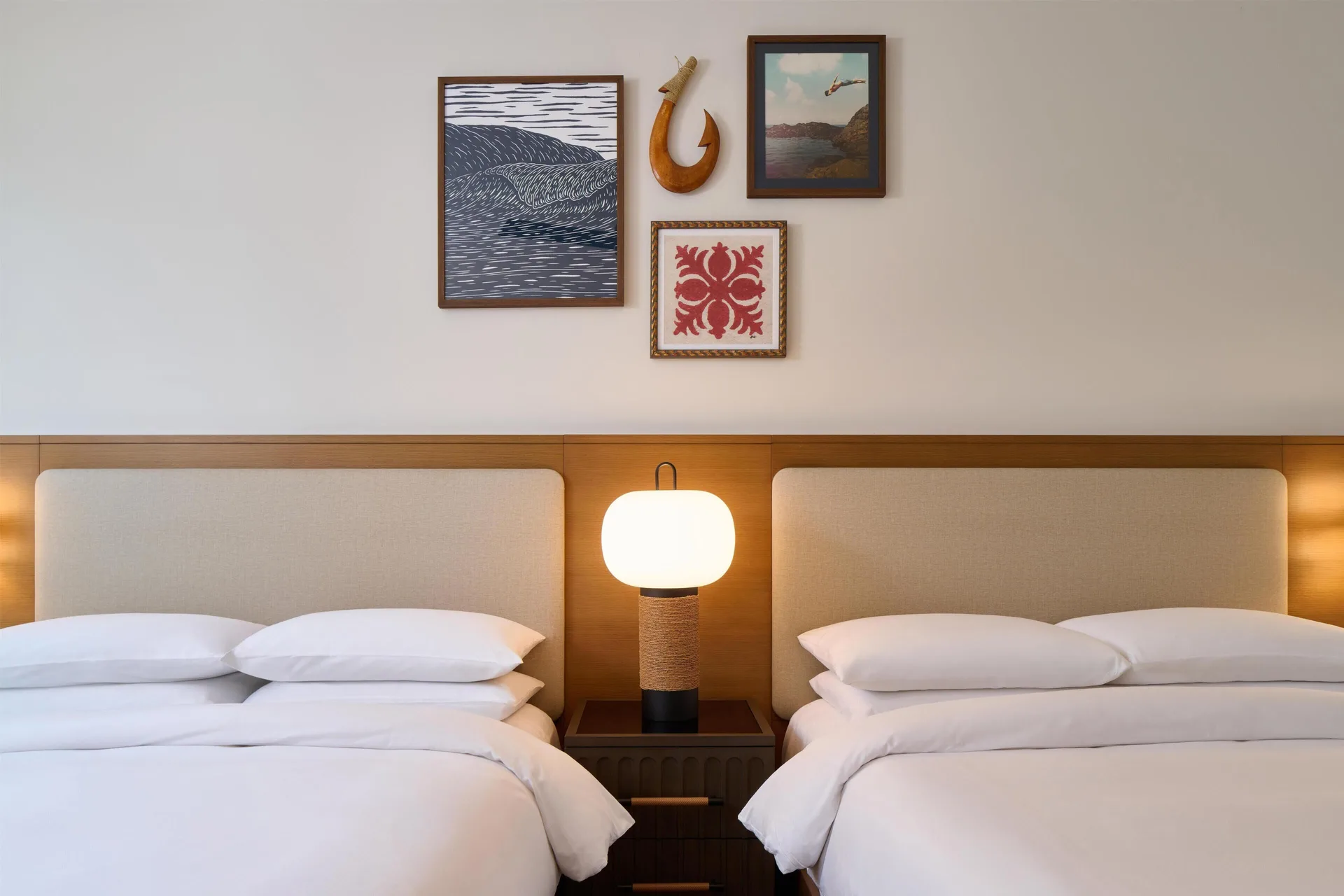 Close view of two beds and bedside lamp in a villa room at Andaz Maui at Wailea Resort.