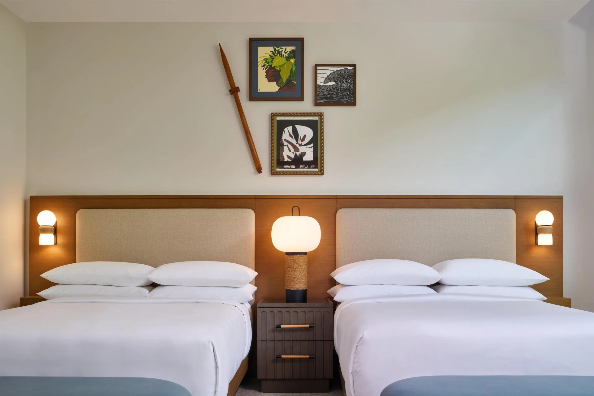 Two beds with wall art in a villa bedroom at Andaz Maui at Wailea Resort.