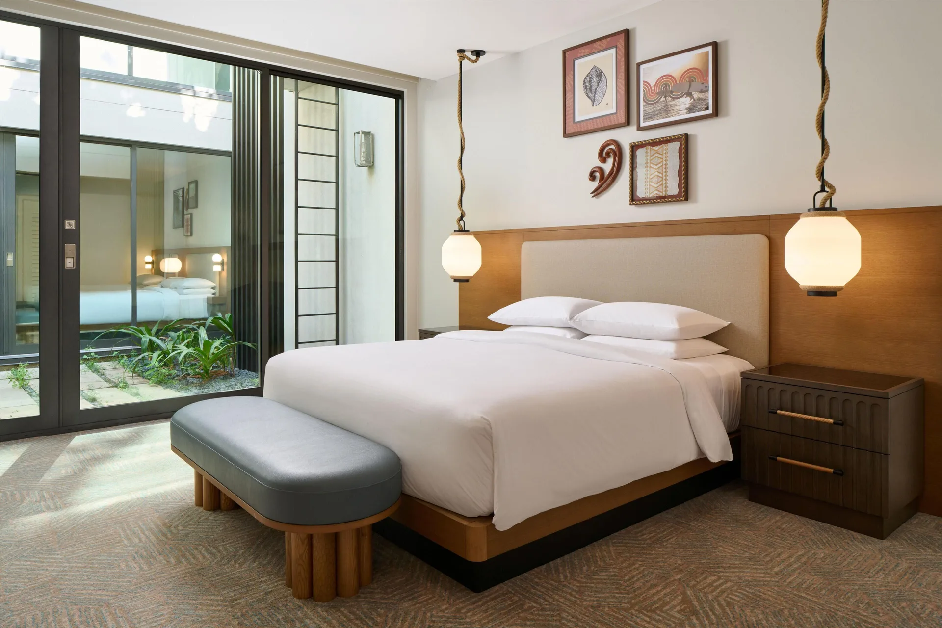 Oceanfront villa bedroom with king bed and courtyard doors at Andaz Maui at Wailea Resort.