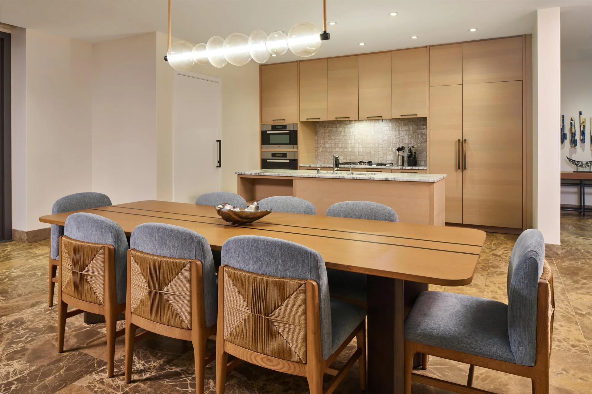 Oceanfront villa dining table and kitchen at Andaz Maui at Wailea Resort.