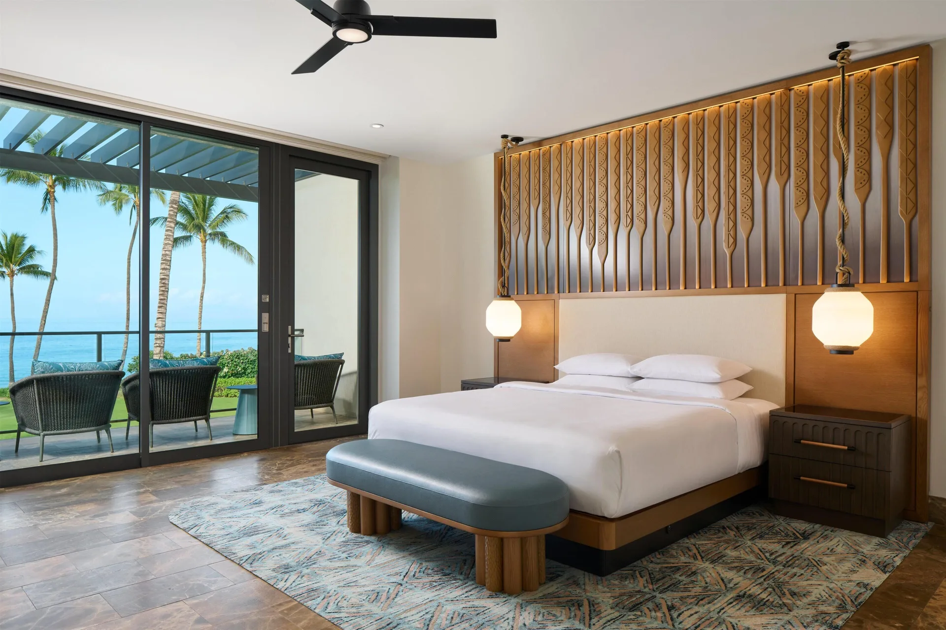 Oceanfront villa bedroom with a king bed, balcony, palms, and ocean view at Andaz Maui at Wailea Resort.
