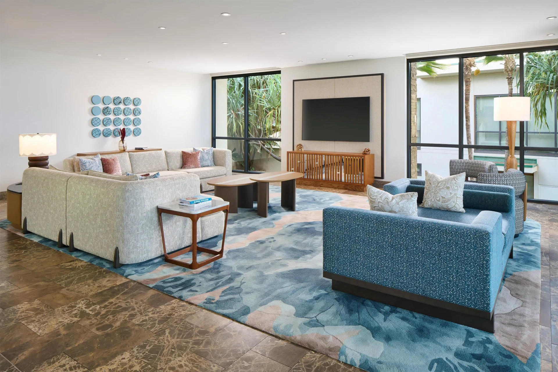 Oceanfront villa lounge area with sofas and wall-mounted TV at Andaz Maui at Wailea Resort.