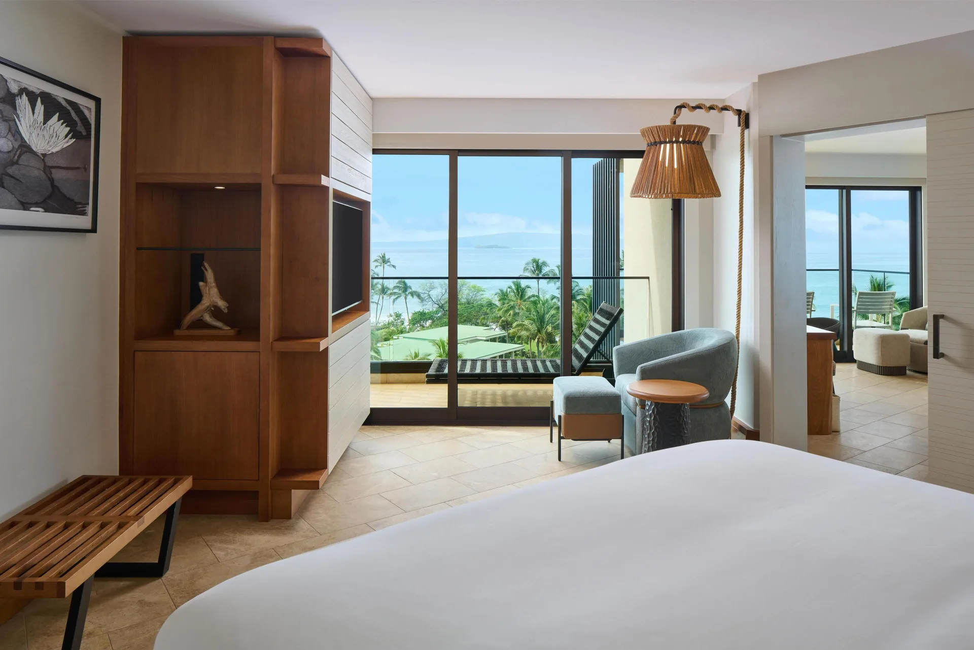 Deluxe Ocean View Suite king bed and sitting area with ocean-view balcony at Andaz Maui at Wailea Resort.