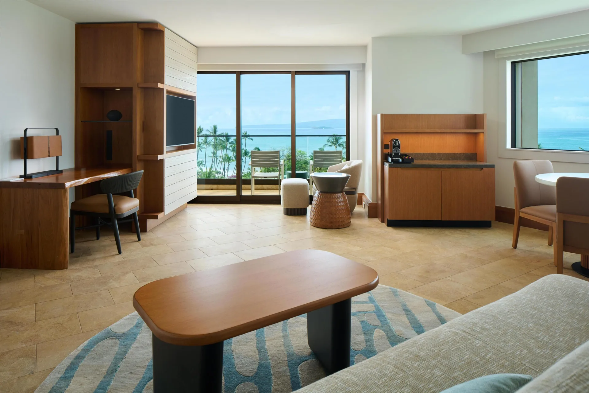 Deluxe Ocean View Suite living area with balcony and ocean view at Andaz Maui at Wailea Resort.