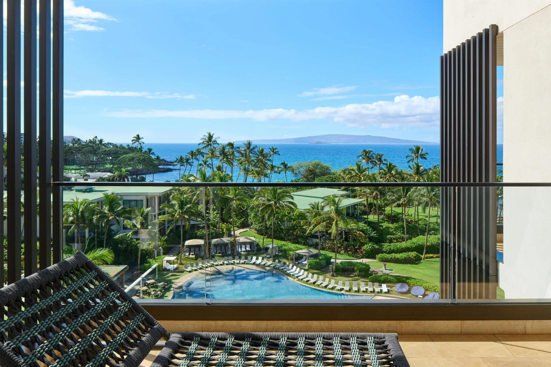 Ocean View Suite balcony with pool, palms, and ocean at Andaz Maui at Wailea Resort.