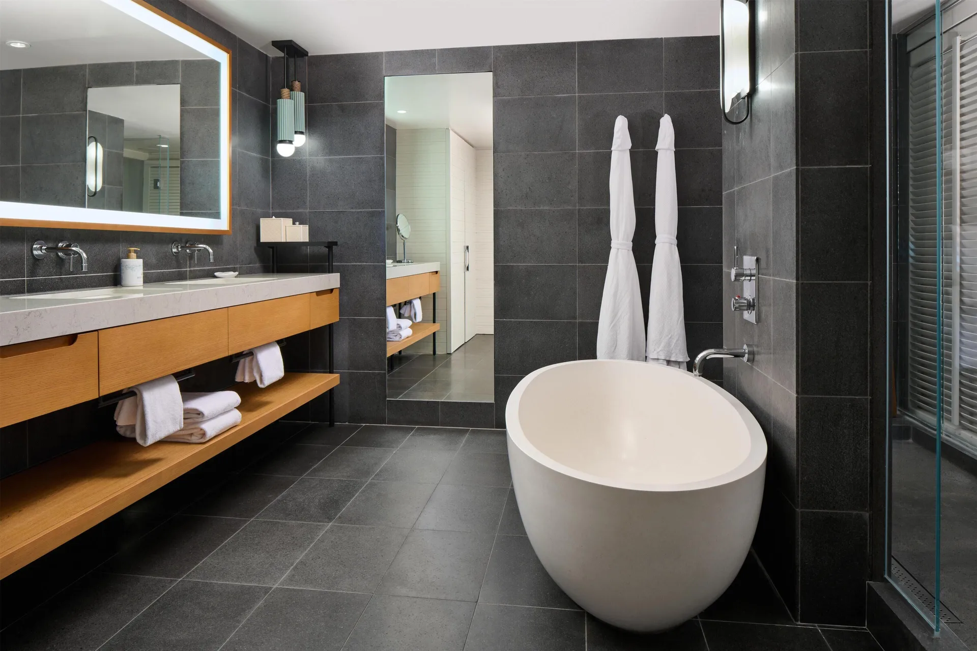 Ocean View Suite bathroom with soaking tub and double vanity at Andaz Maui at Wailea Resort.