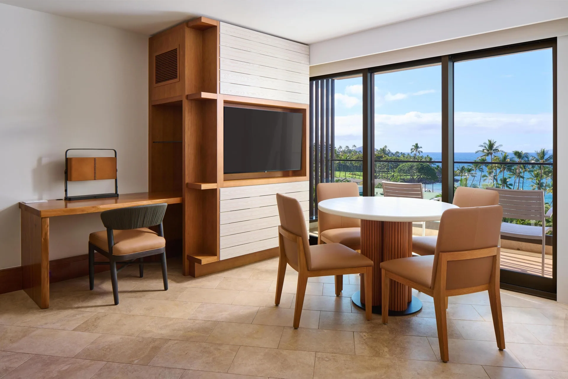 Ocean View Suite dining table, desk, TV, and balcony at Andaz Maui at Wailea Resort.