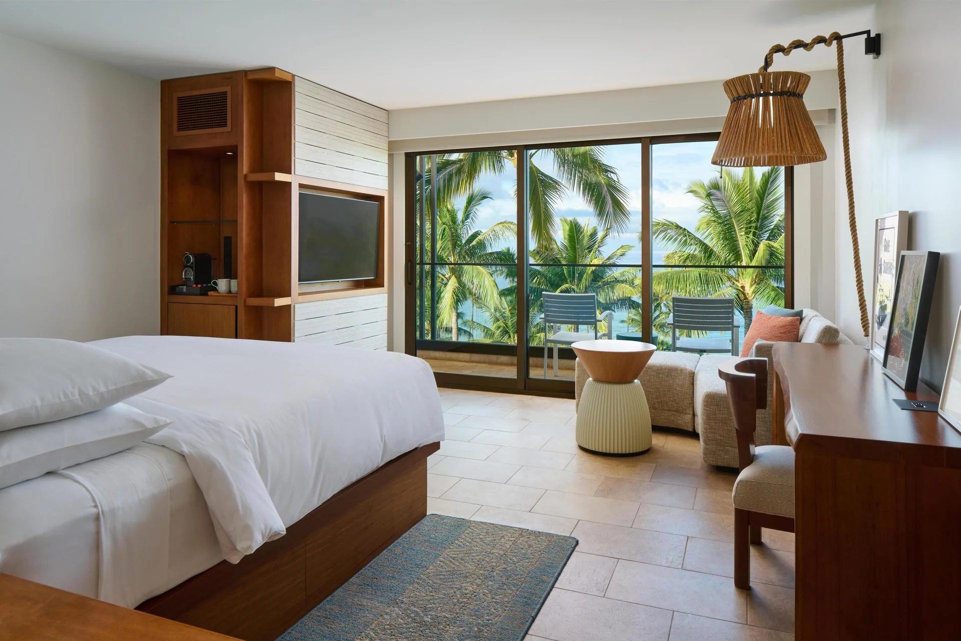 King bed ocean view room with balcony and palm trees at Andaz Maui at Wailea Resort.