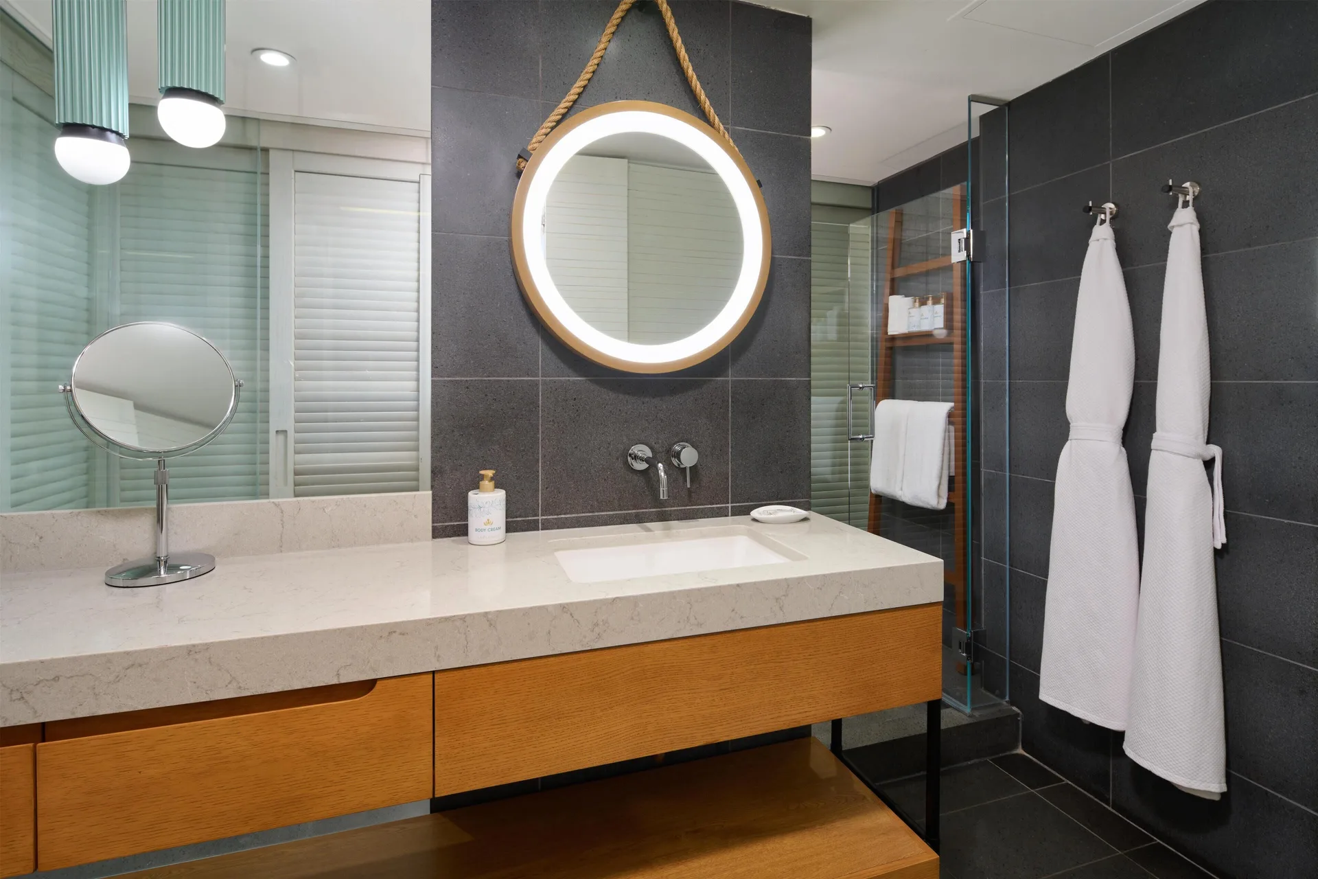 Resort view room bathroom vanity and shower at Andaz Maui at Wailea Resort.