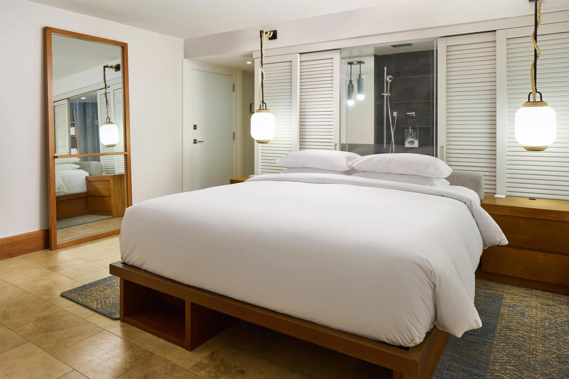 King bed and glass shower wall in a resort view room at Andaz Maui at Wailea Resort.