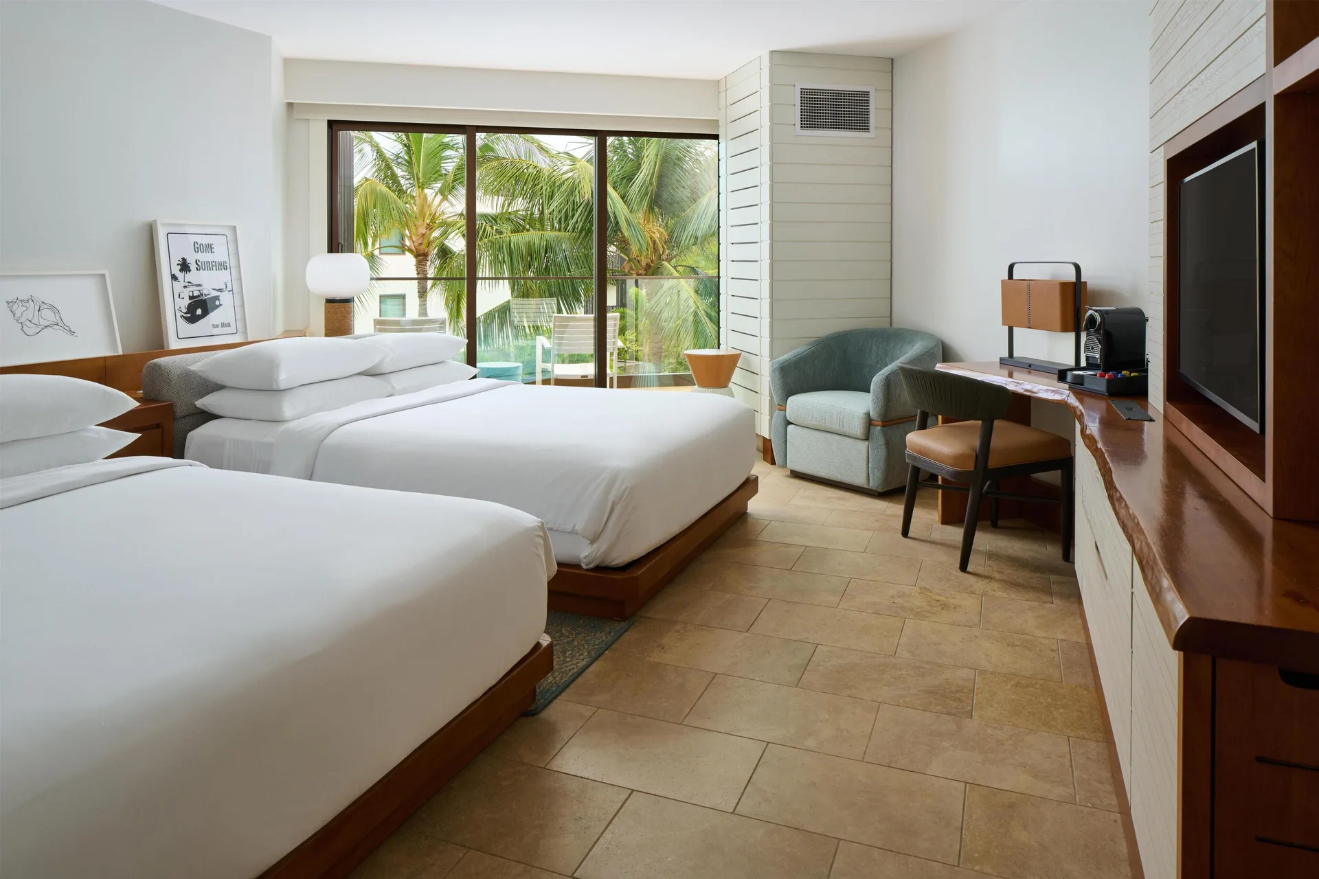 Two queen beds, balcony, desk, and palm view in a resort view room at Andaz Maui at Wailea Resort.