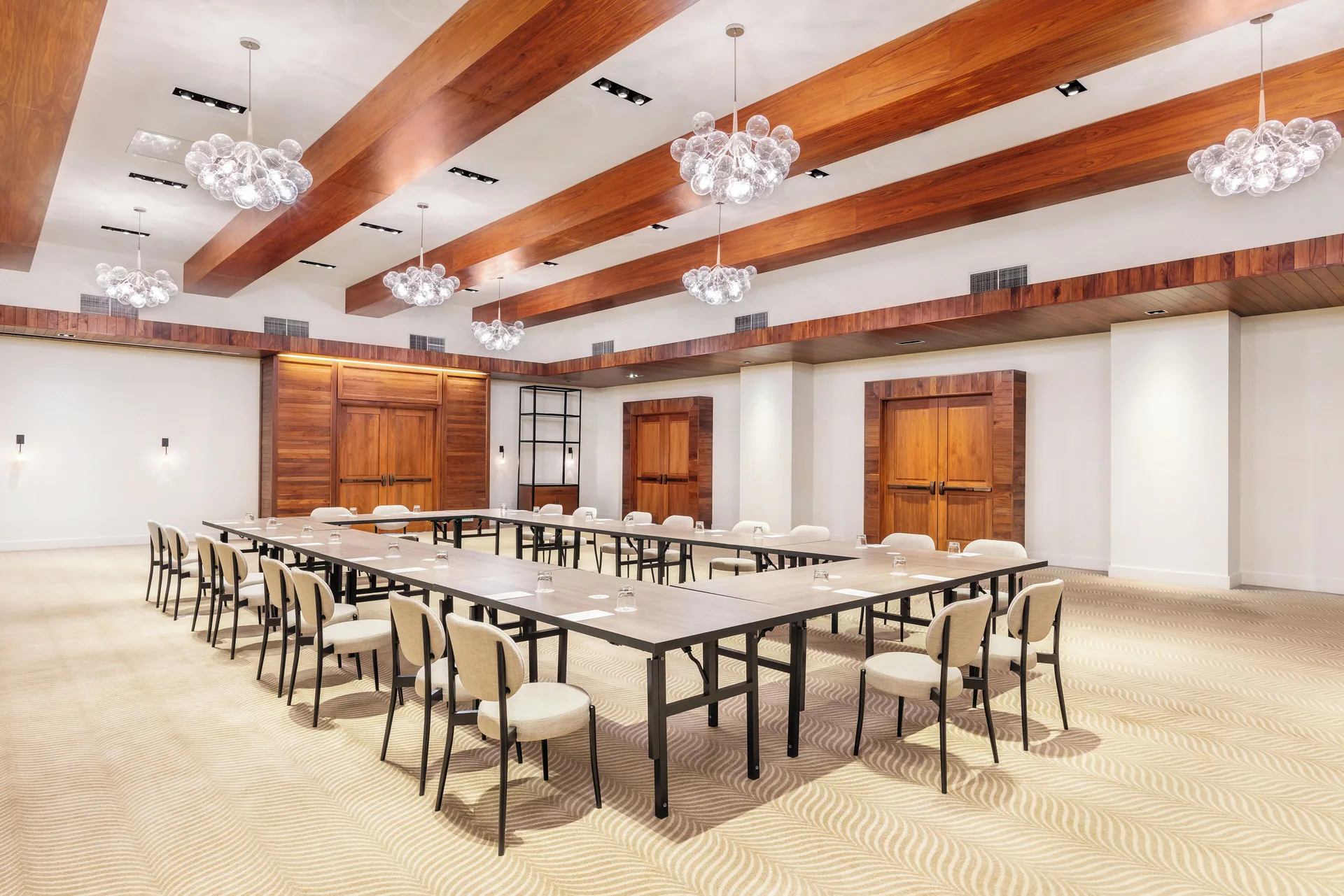 Meeting room with U-shaped tables and chandeliers at Andaz Maui at Wailea Resort.