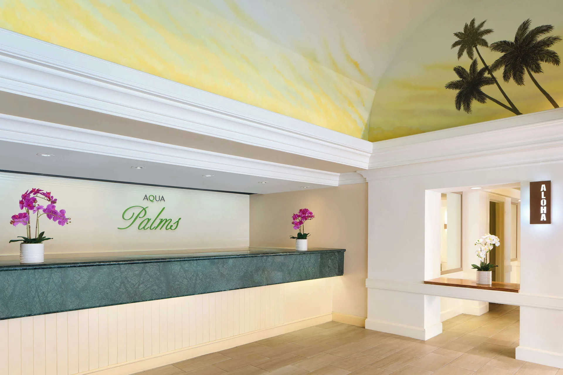 Front desk and reception area with Aqua Palms Waikiki signage at Aqua Palms Waikiki.