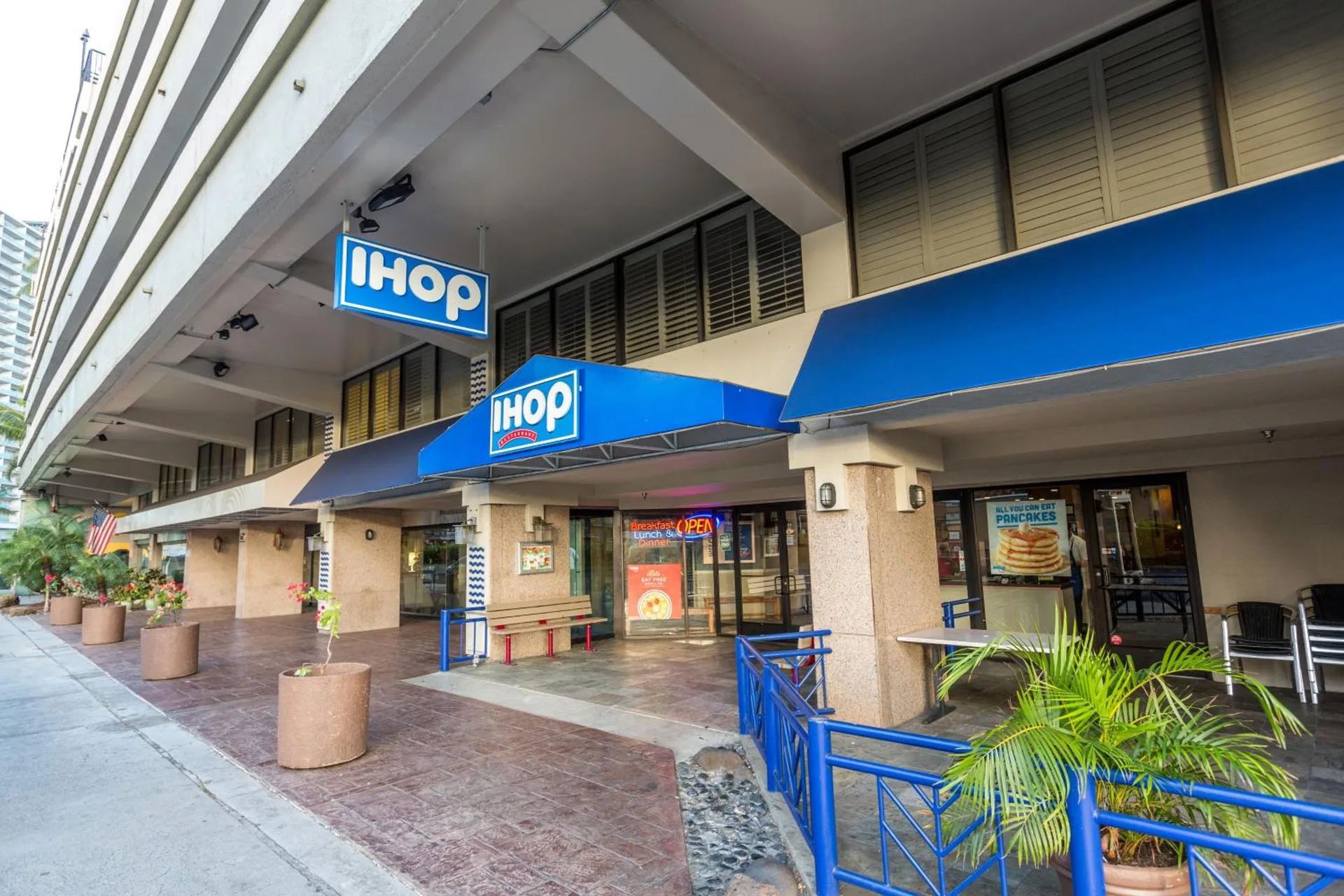 IHOP entrance with blue awnings along the hotel exterior at Aqua Palms Waikiki.