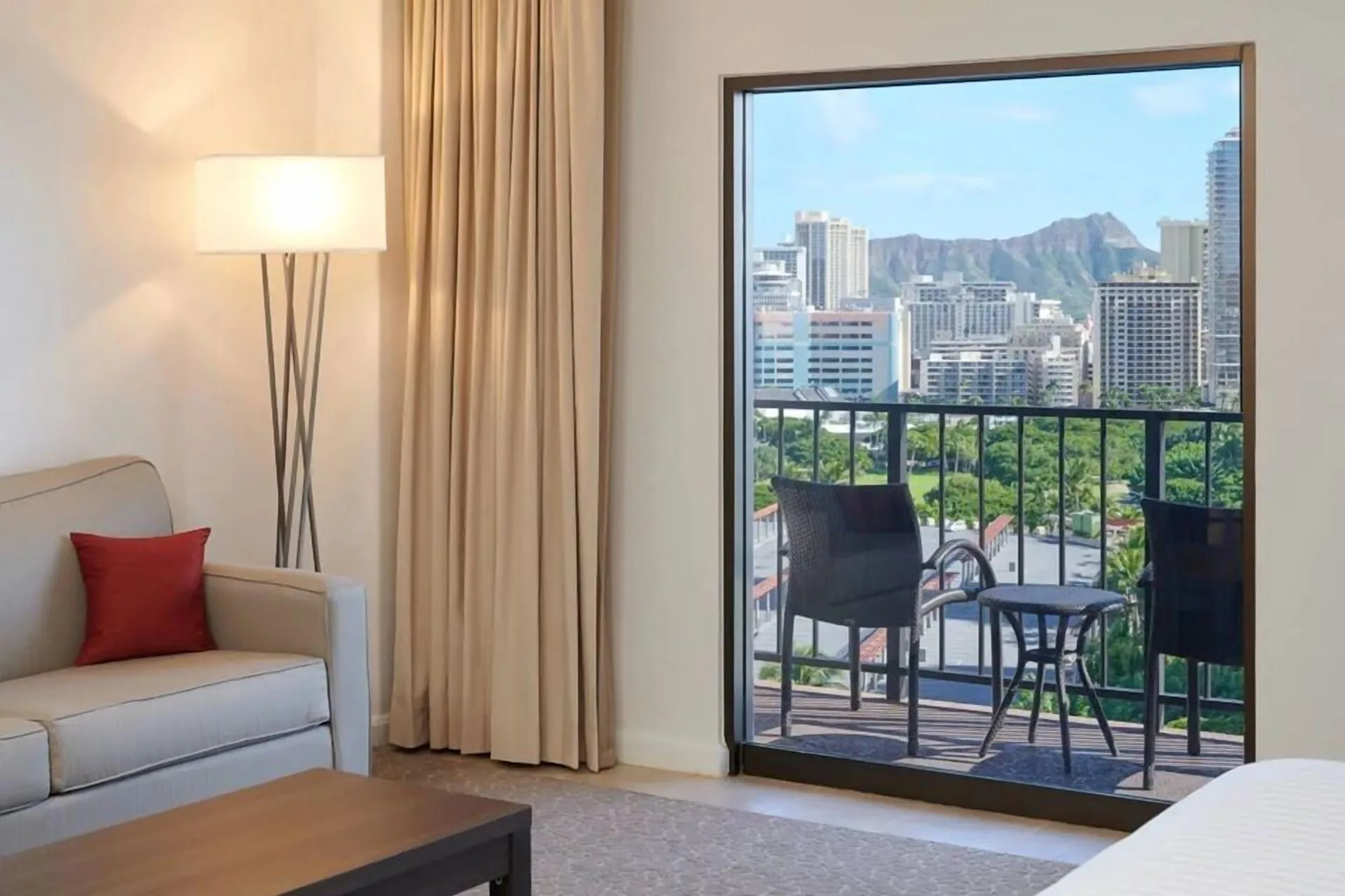 Junior Suite sitting area and balcony city view at Aqua Palms Waikiki.