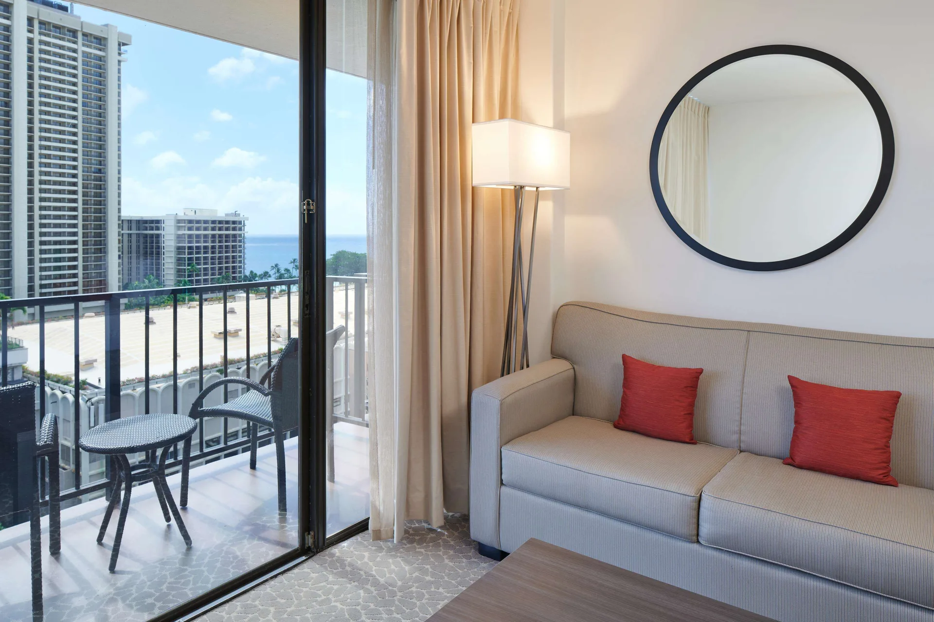 Partial Ocean View room sitting area and balcony at Aqua Palms Waikiki.