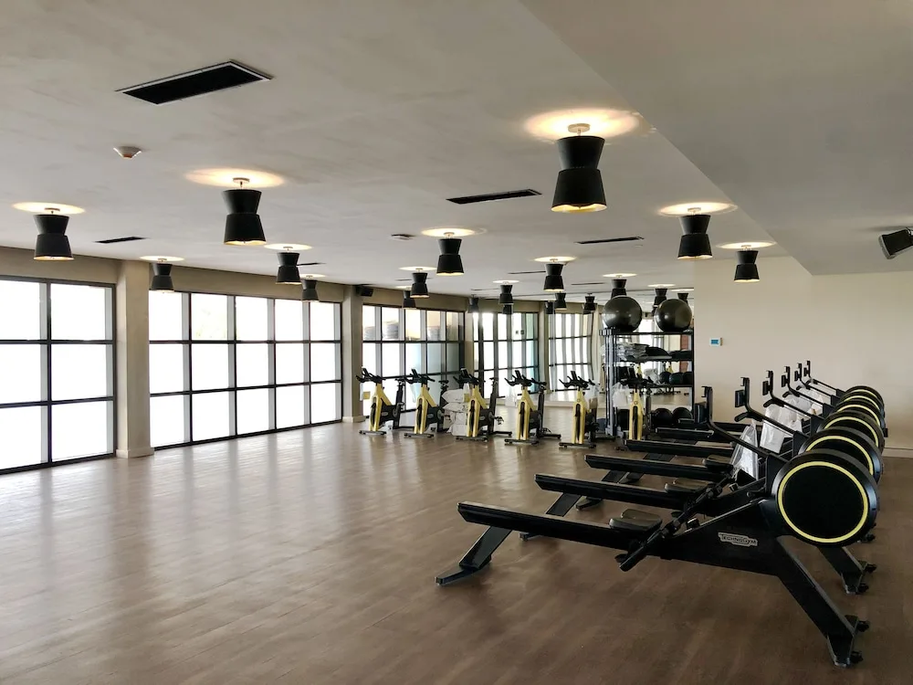 Exercise studio with rowing machines and spin bikes at Atelier Playa Mujeres.