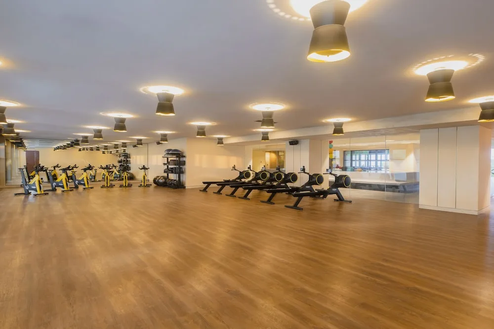 Open workout studio with bikes and rowing machines at Atelier Playa Mujeres.