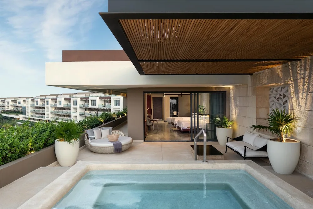 Suite terrace with private plunge pool and lounge seating at Atelier Playa Mujeres.