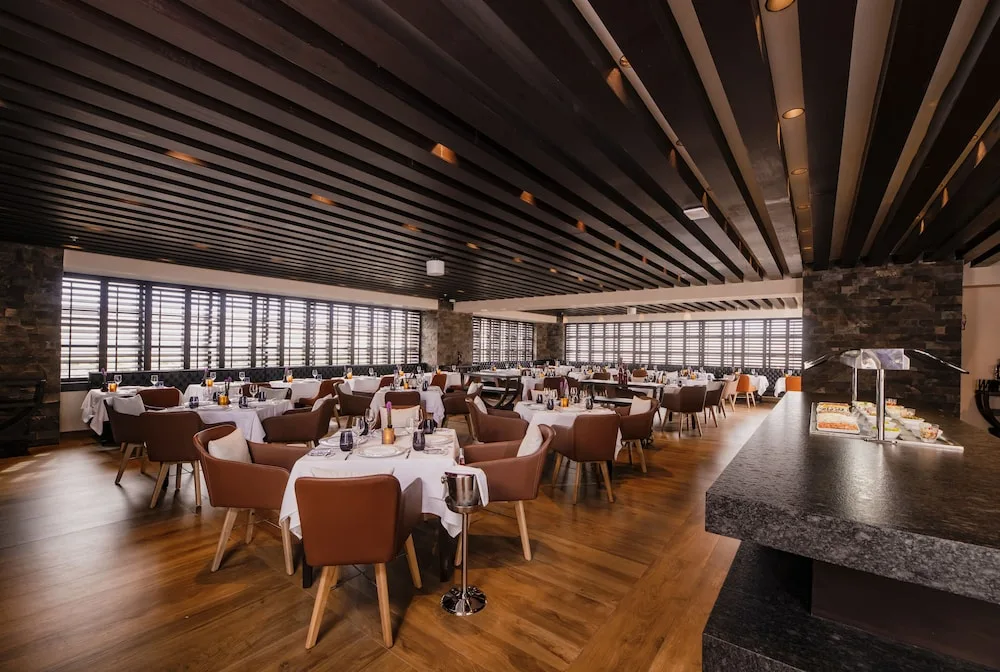 Large dining room with buffet counter and shuttered windows at Atelier Playa Mujeres.