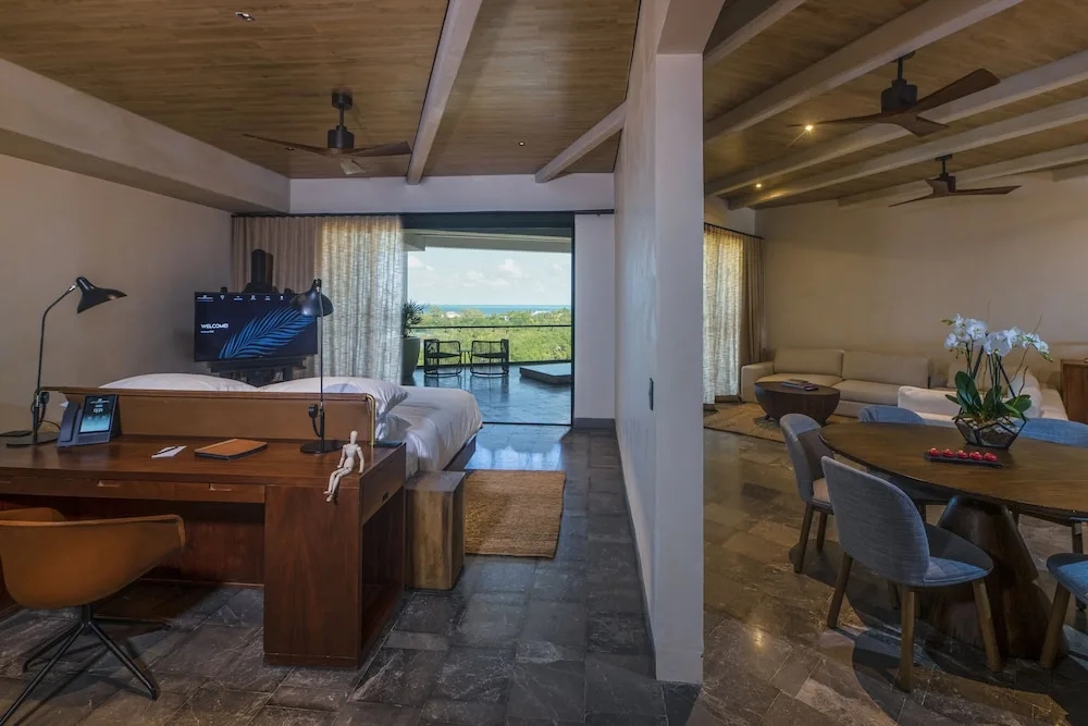 Inspira Business Suite with bed, desk, dining area and terrace at Atelier Playa Mujeres.