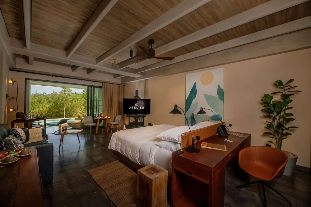 Inspira Junior Suite Swim Out king bed and terrace at Atelier Playa Mujeres.