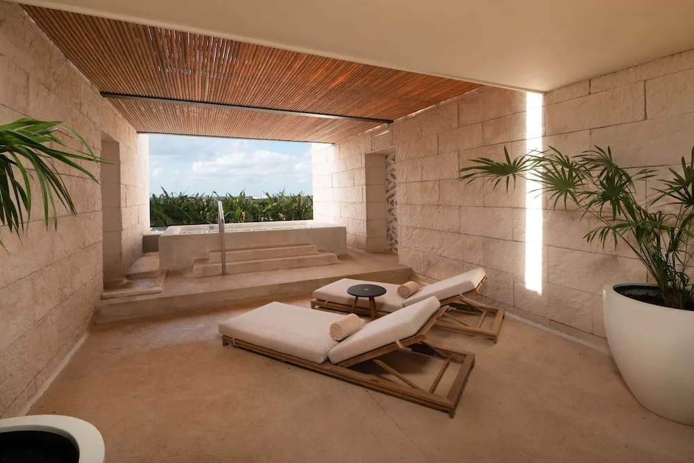 Private terrace with loungers and plunge tub for an Inspira Terrace Suite at Atelier Playa Mujeres.