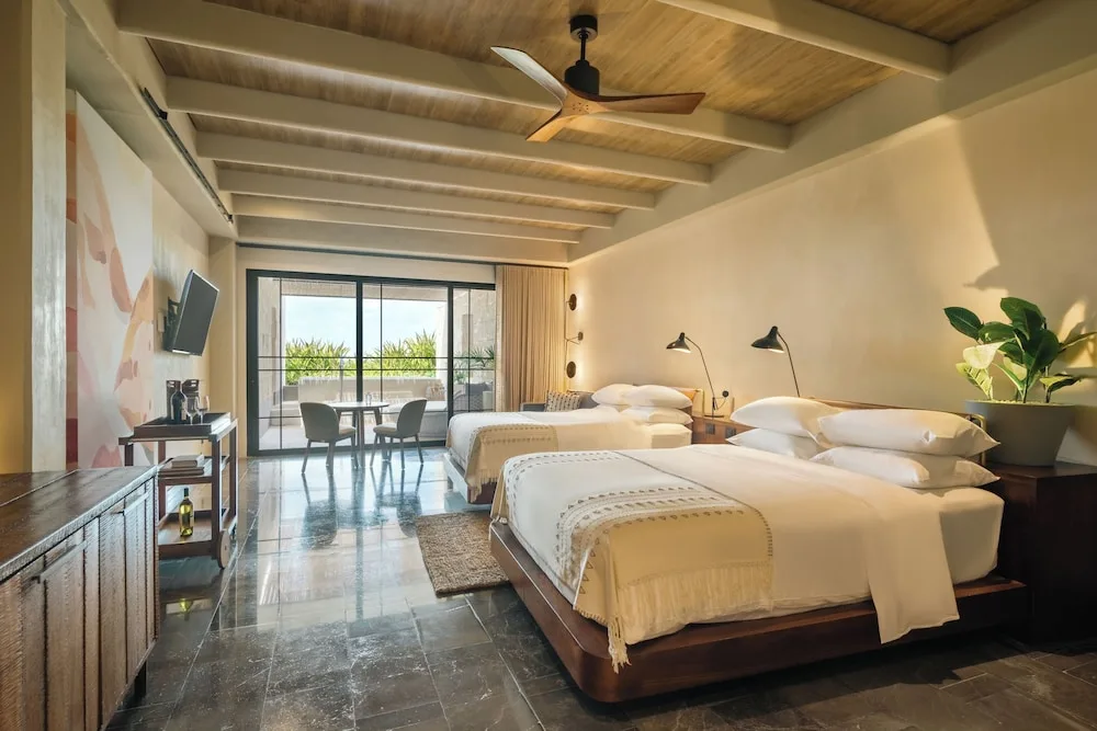 Inspira Terrace Suite with two beds at Atelier Playa Mujeres featuring spacious terrace access, contemporary design, and premium Inspira Collection amenities.
