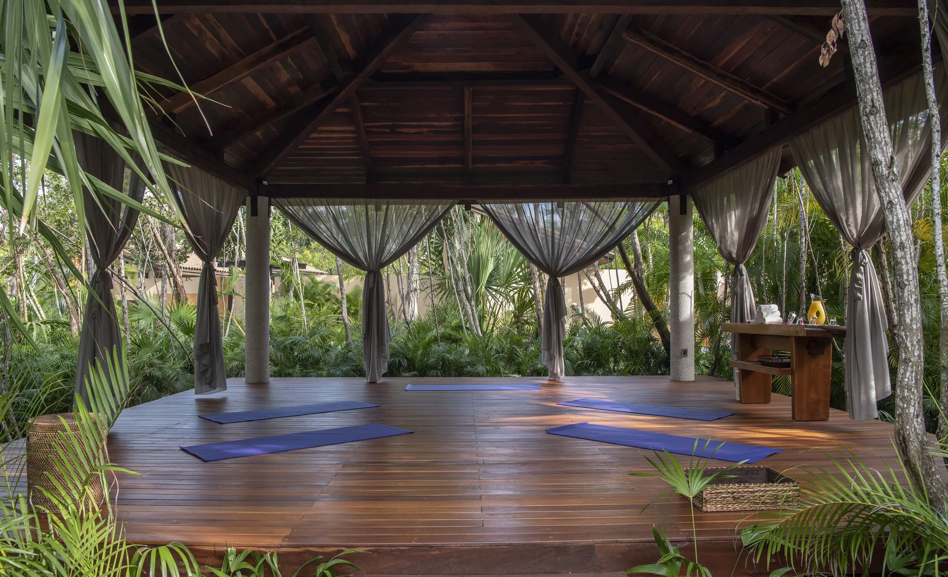 Open-air yoga pavilion with mats in the jungle at Banyan Tree Mayakoba.