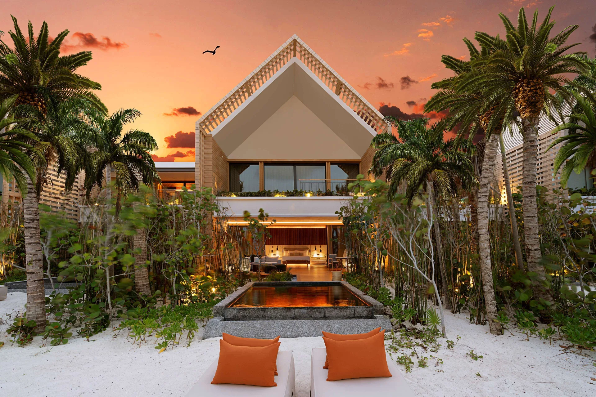 Beachfront Lanai Pool Suite exterior at Banyan Tree Mayakoba with private pool and palms at sunset.