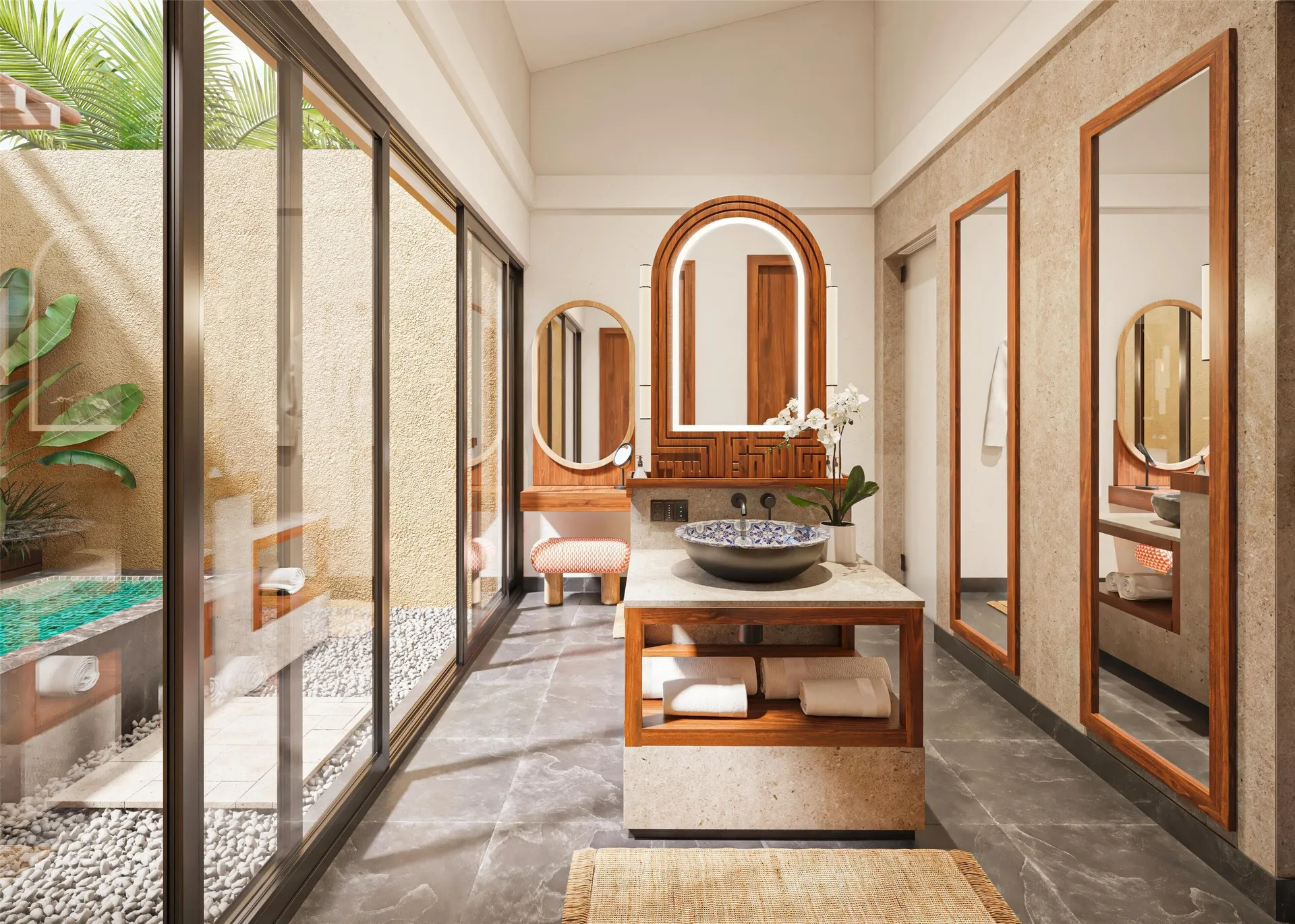 Bliss Pool Villa bathroom vanity with mirrors and poolside glass doors at Banyan Tree Mayakoba.