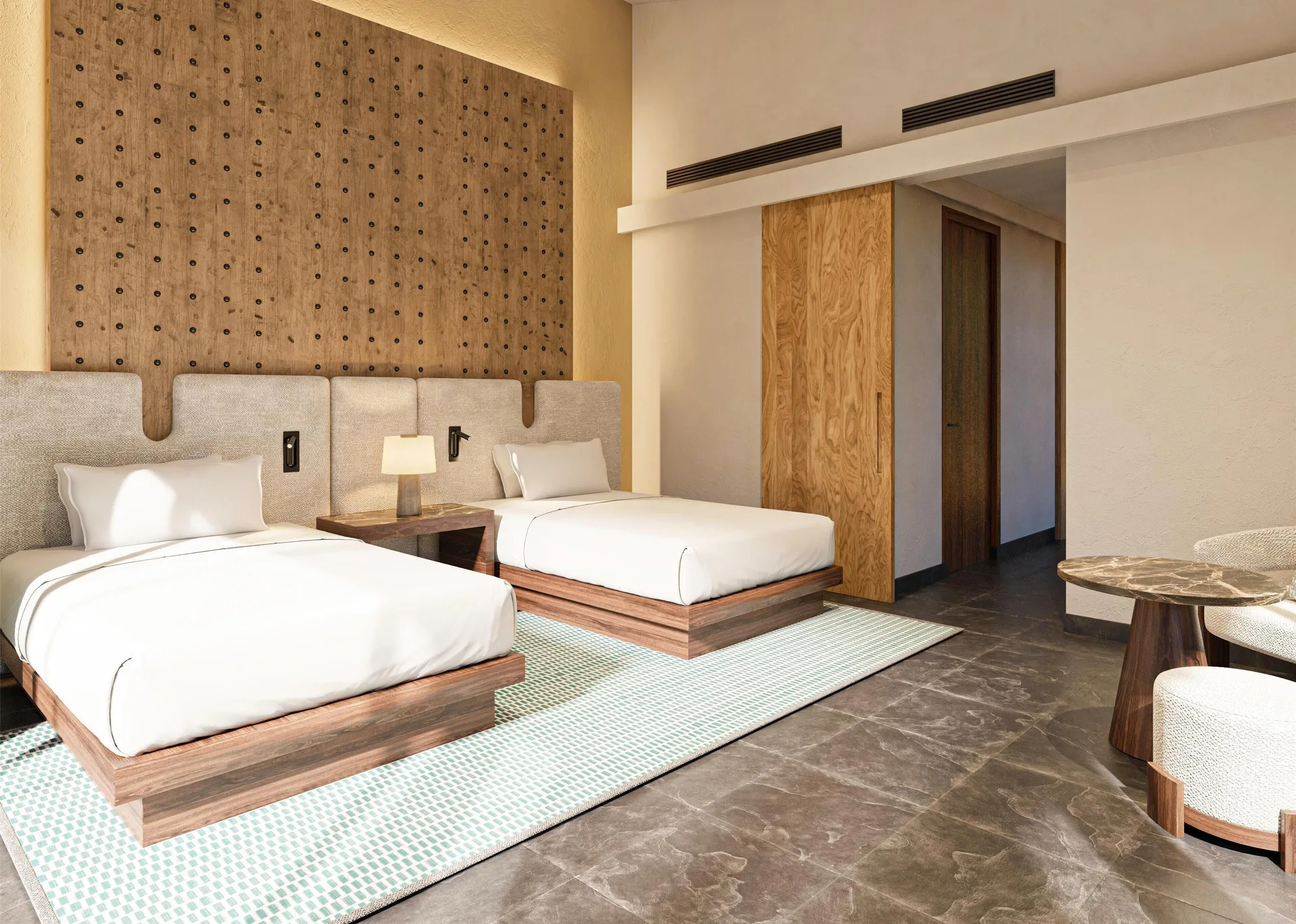 Two twin beds in the Harmony Three-Bedroom Beachfront Pool villa at Banyan Tree Mayakoba.