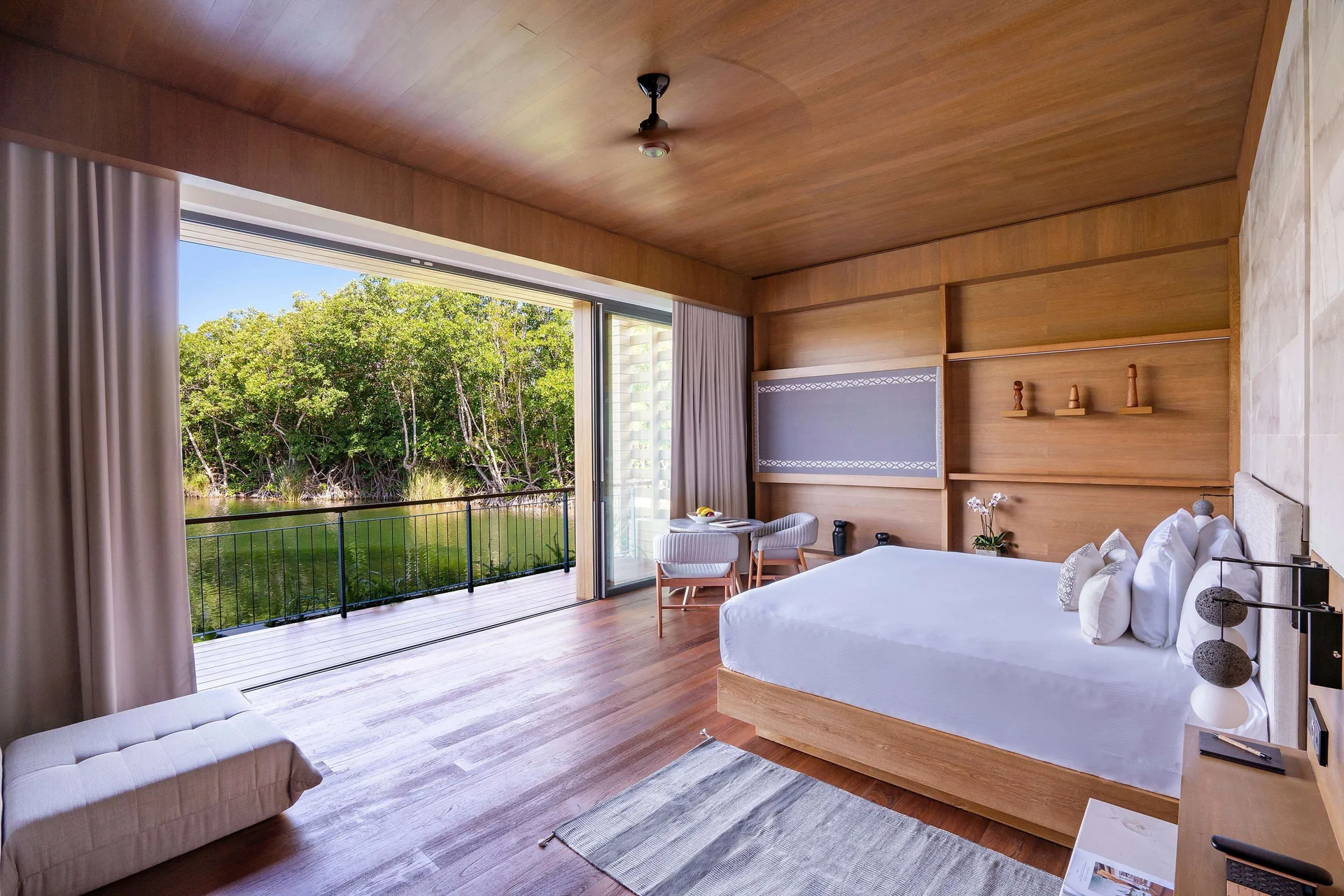 Lagoon & Sunset Rooftop Pool Villa king bedroom with lagoon balcony at Banyan Tree Mayakoba.